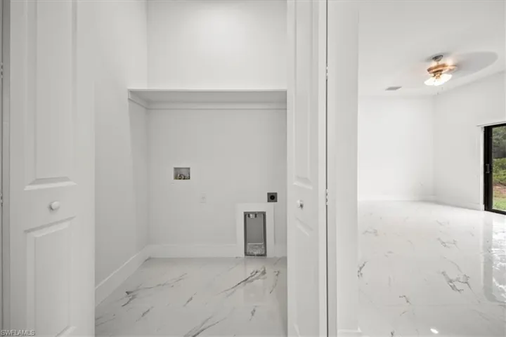 Laundry area with washer hookup, marble finish floors, hookup for an electric dryer, and ceiling fan