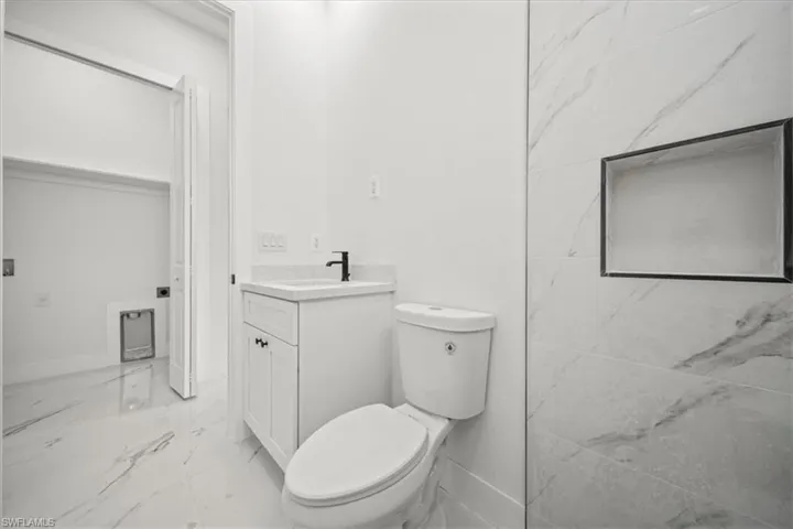 Bathroom with marble finish floors and vanity