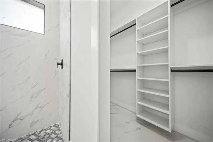 Spacious closet with marble finish floors
