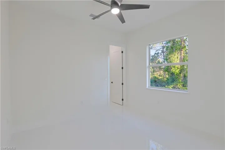 Tiled spare room with baseboards and ceiling fan