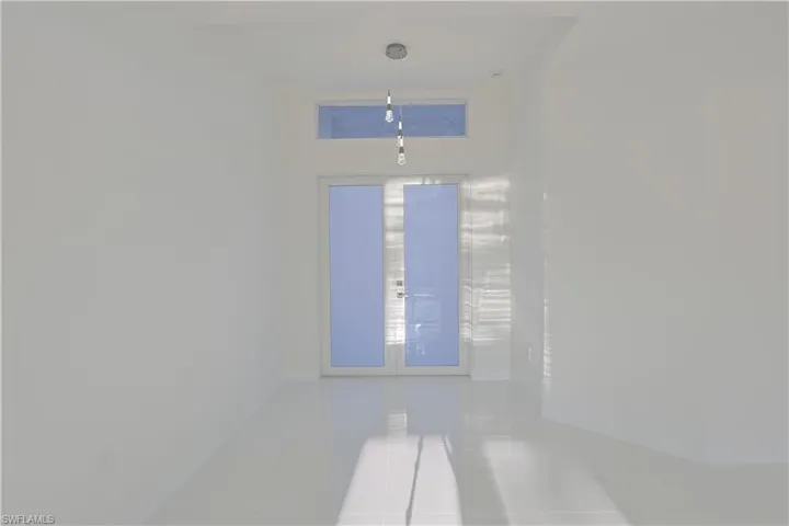 Unfurnished room featuring tile patterned floors and baseboards
