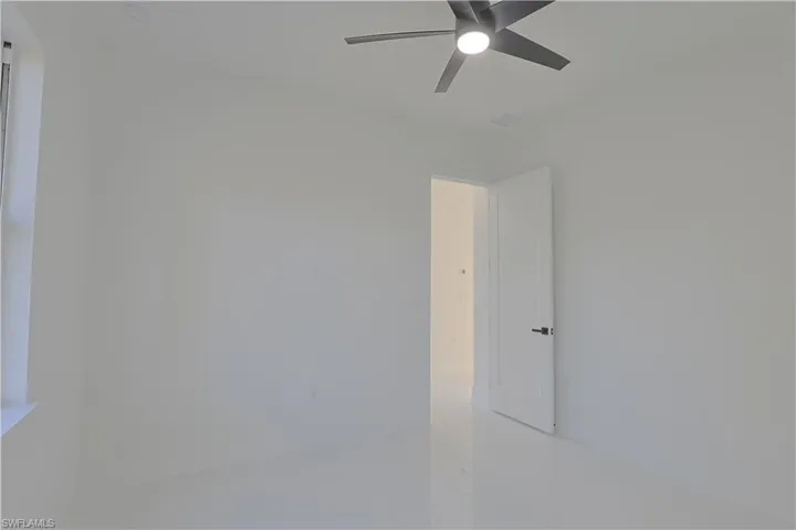 Unfurnished room featuring a ceiling fan