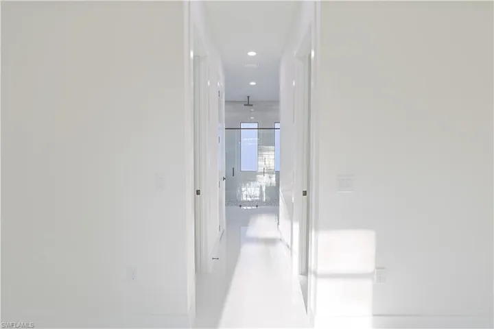 Hallway with tile patterned floors and recessed lighting