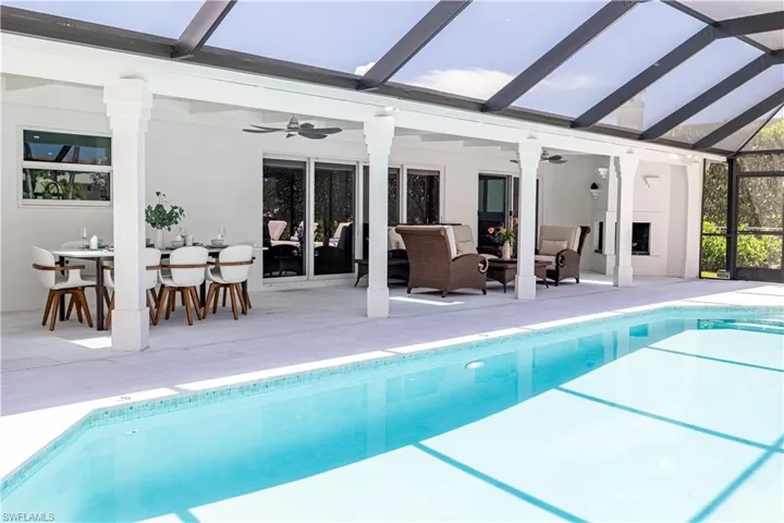 Outdoor pool featuring ceiling fan, outdoor lounge area, and a patio
