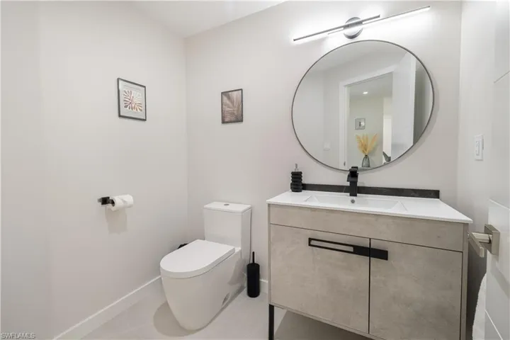 Half bathroom with vanity and tile patterned flooring