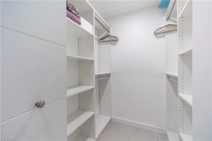 Spacious closet with light tile patterned floors