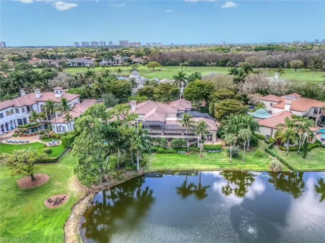 Bird's eye view of a nearby body of water, skyline, and a golf club