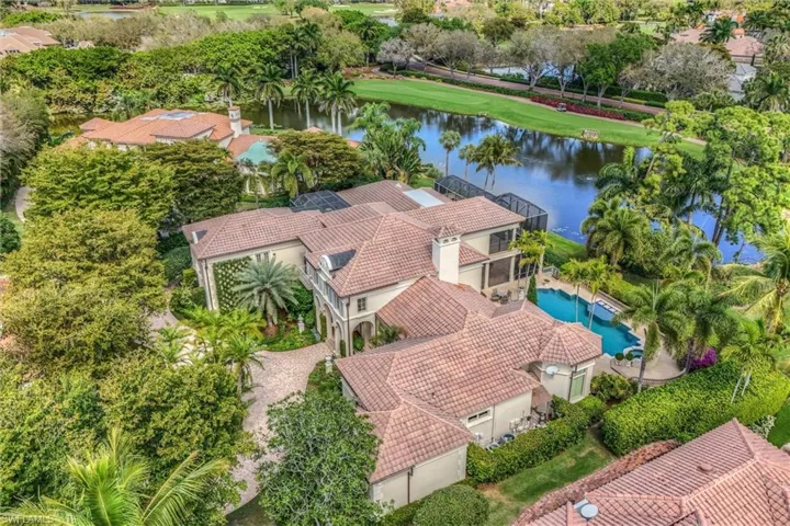 Aerial view of property and surrounding area featuring a nearby body of water