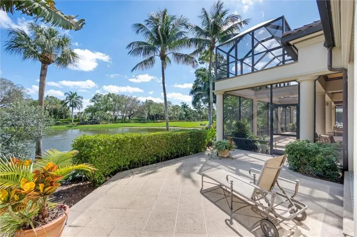 View of patio featuring a sunroom and a water view