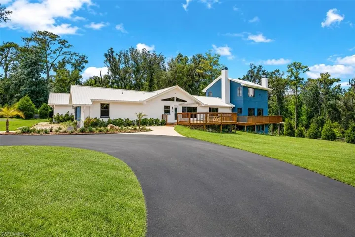 Welcome to a spacious rural property offering privacy, open land, and multiple structures including a residence and detached garage buildings.