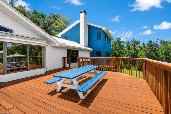 Comfortable exterior deck space offering a quiet retreat with views of the expansive acreage.