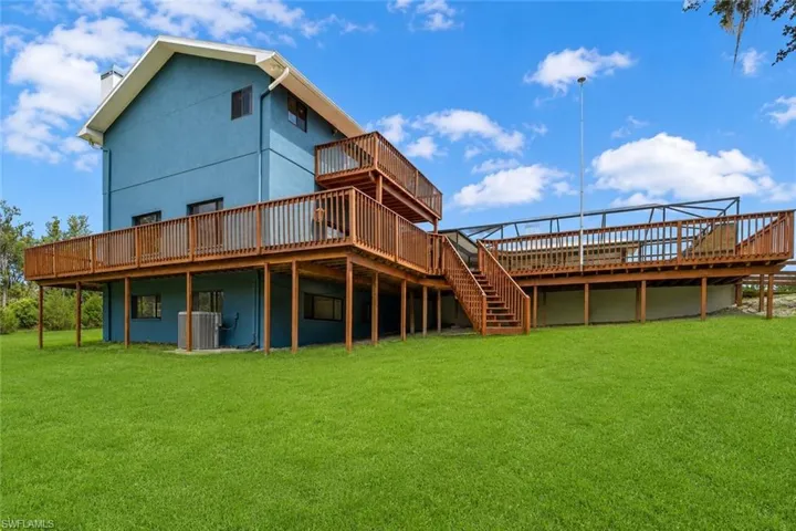 Rear view of the residence showcasing its private setting surrounded by natural Florida landscape and open space.