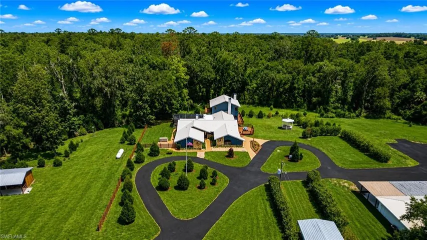 Aerial perspective showcasing the extraordinary scale of the estate's commercial and storage facilities, including multiple high-capacity structures designed for vehicle collections, equipment storage, business operations, and future expansion.