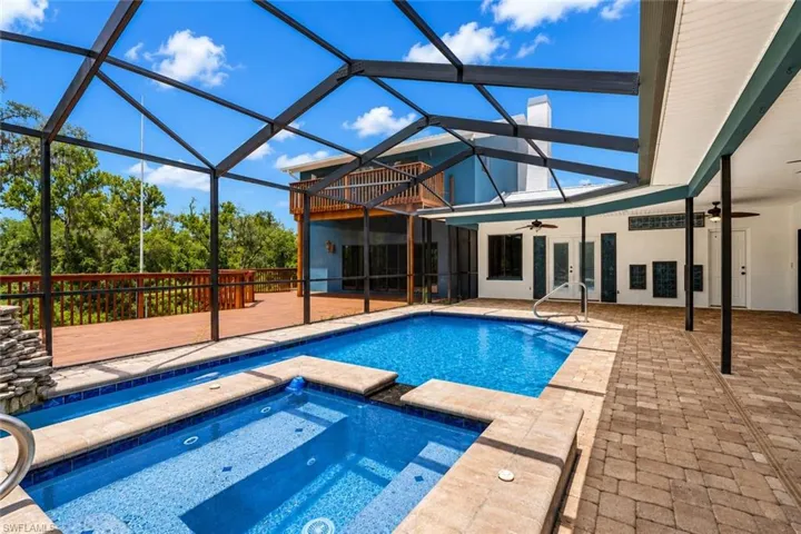 Functional pool and spa setup presenting opportunity for renovation, enhancement, or repositioning as a key lifestyle feature.