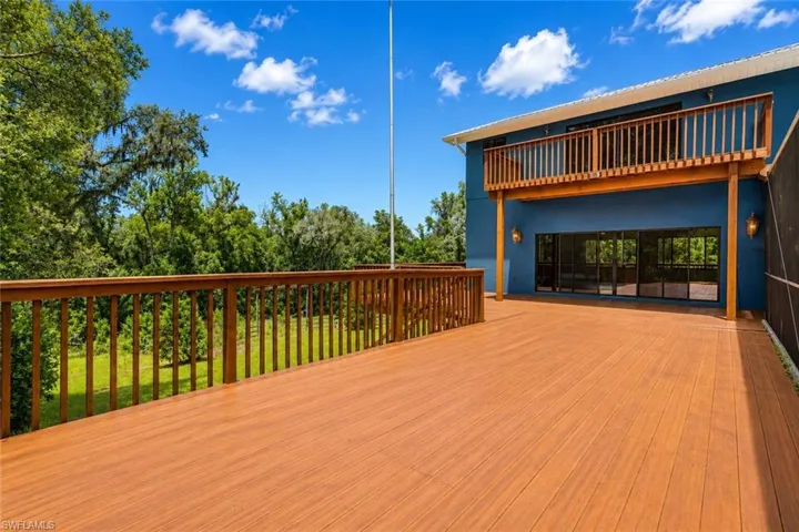 Expansive two-story wraparound deck spanning three sides of the home, ideal for outdoor entertaining and scenic enjoyment.
