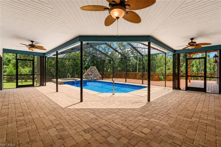 Rear view of the residence showcasing its private setting surrounded by natural Florida landscape and open space.