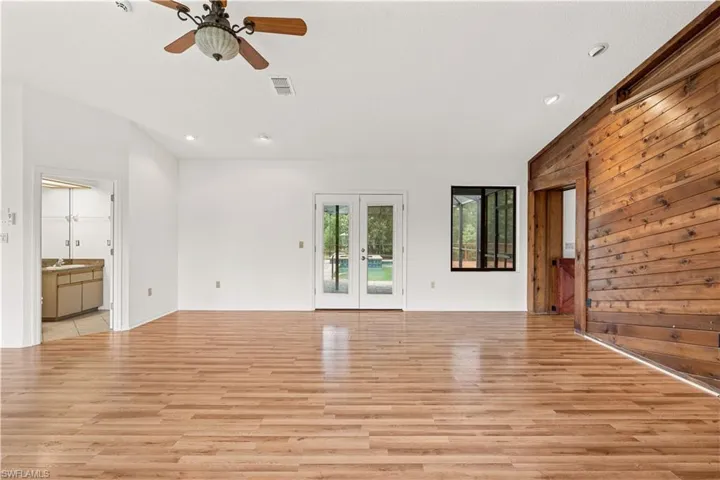 Inviting living space featuring a fireplace framed by a warm wood accent wall and a built-in bar area, creating an ideal setting for relaxing and entertaining.