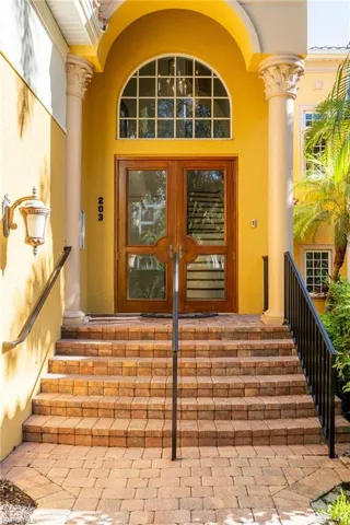 View of exterior entry featuring french doors and stucco siding