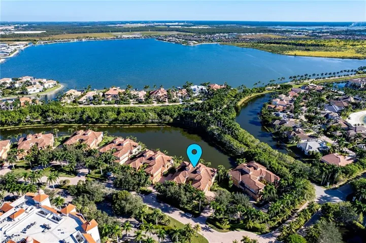Aerial view of property's location featuring nearby suburban area and a large body of water