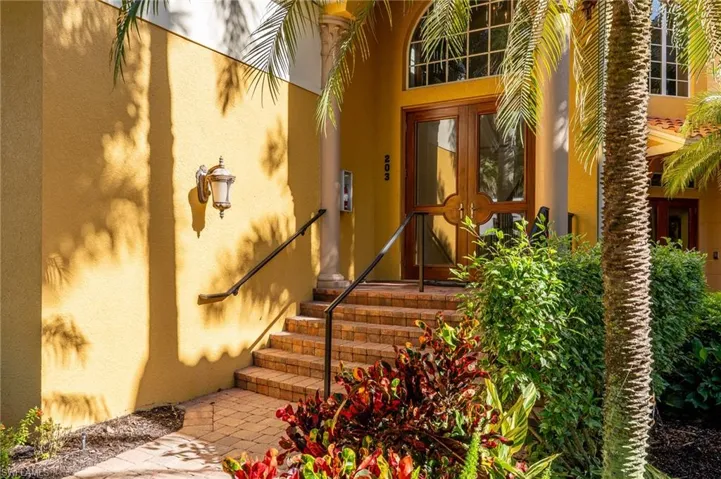 Entrance to property with stucco siding