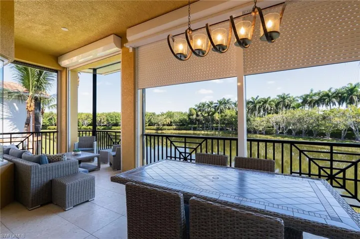 Sunroom with a water view and a chandelier