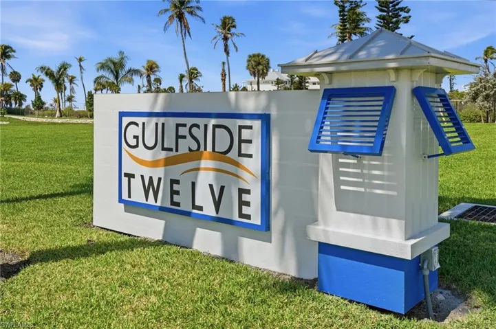 Community sign featuring a lawn