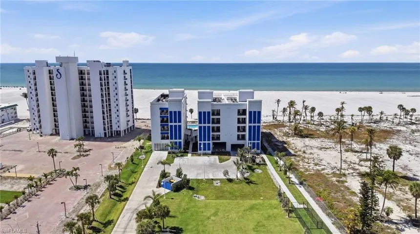 Aerial view of unending shoreline and apartment complex / building