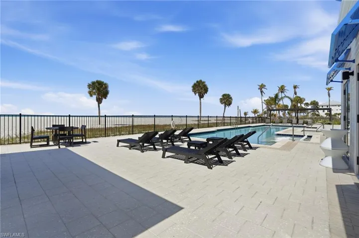 Community pool with a patio