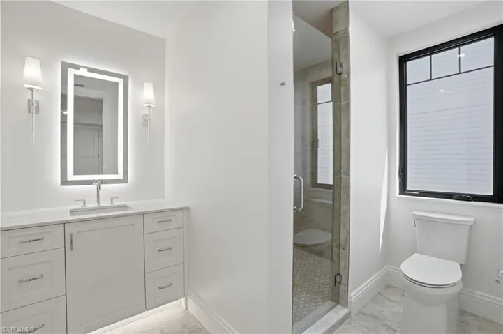Bathroom with vanity and a stall shower