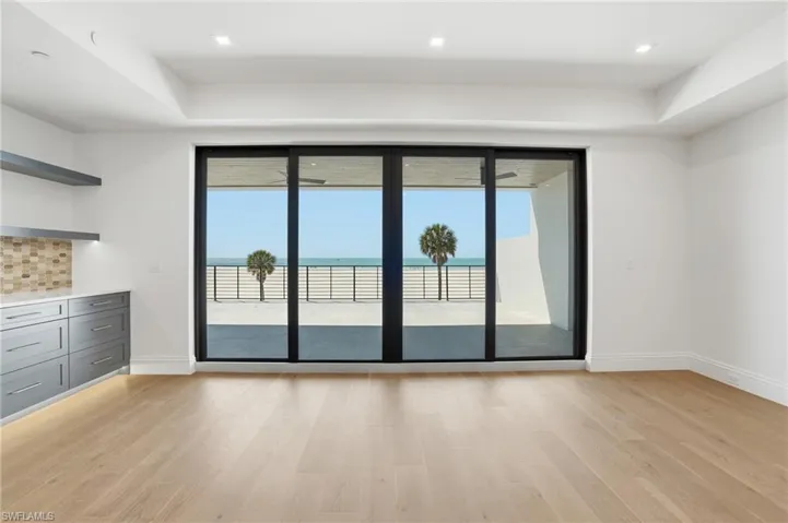 Unfurnished room with light wood-style floors, a water view, and recessed lighting