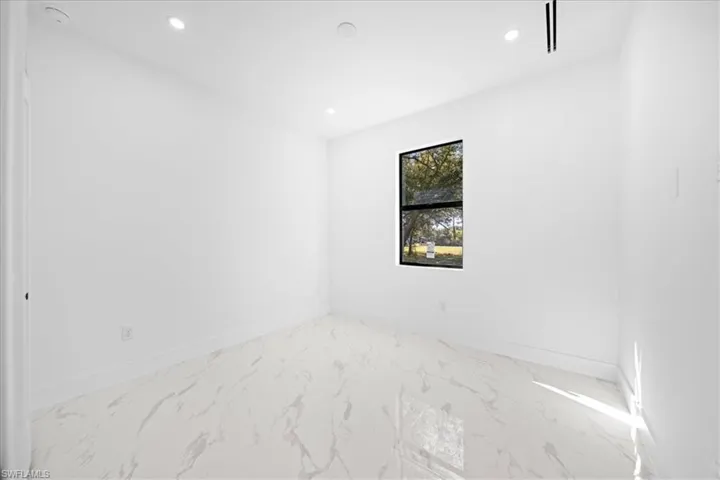 Empty room with recessed lighting and light marble finish floors