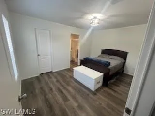Bedroom with dark wood-style flooring