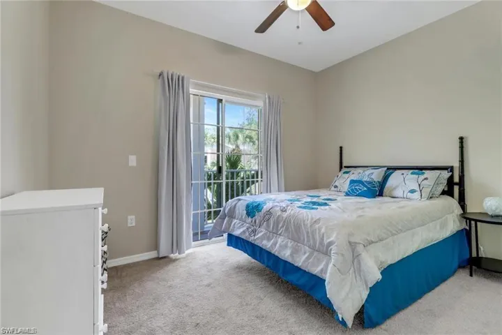Bedroom with access to outside, carpet flooring, a ceiling fan, and baseboards