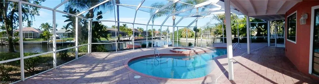 Hard to find such a Beautiful property for this acceptable price.  View of the pool with an in ground hot tub, a excellent water view, screen enclosure, and a huge patio area