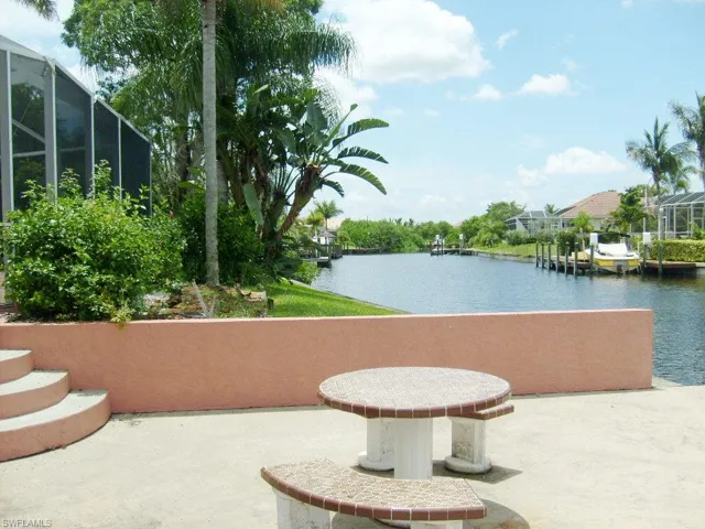 View of dock table set, patio screen with a water view