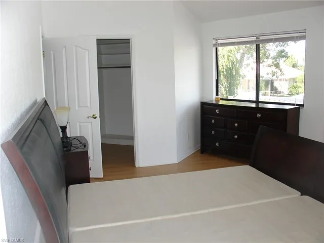 Master Bedroom featuring light hardwood / wood-style floors and a big walk in closet