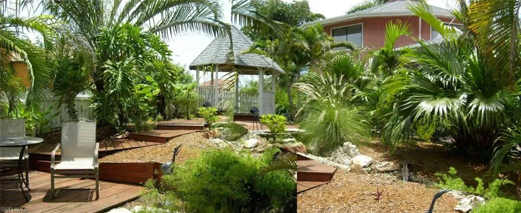 View from canal side and sundeck over to the tropical yard , gazebo and the house