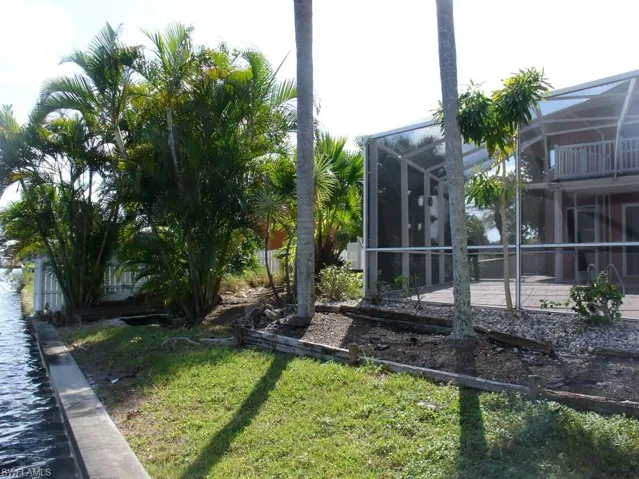 View of north west side yard with patio screen enclosure