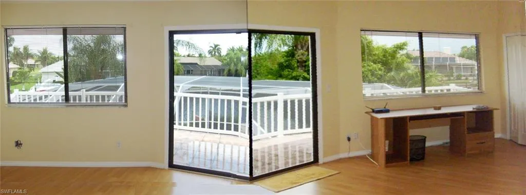 Master bedroom with Sliding Door to Balcony outside is featuring wood-type flooring
