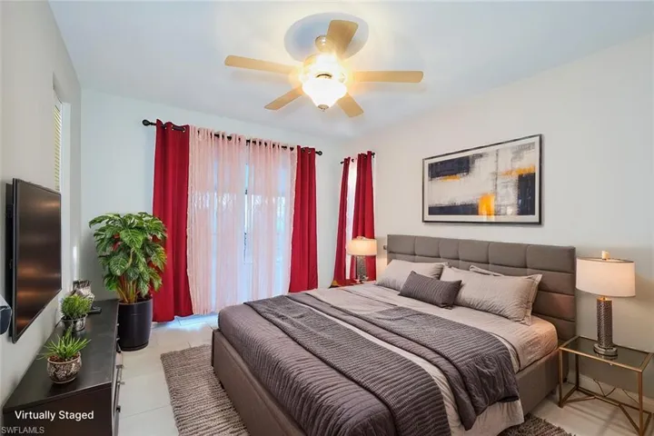Primary Bedroom featuring ceiling fan and light tile patterned flooring