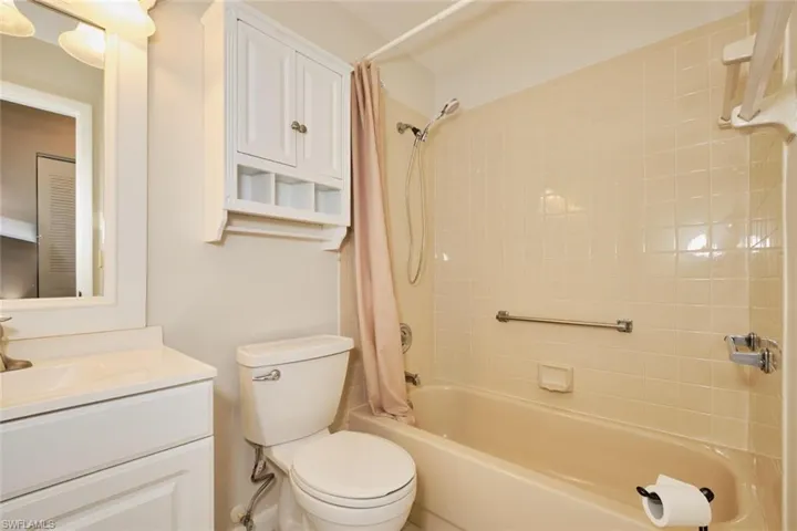 Second Full bathroom with vanity, shower / bath combination with curtain, and toilet