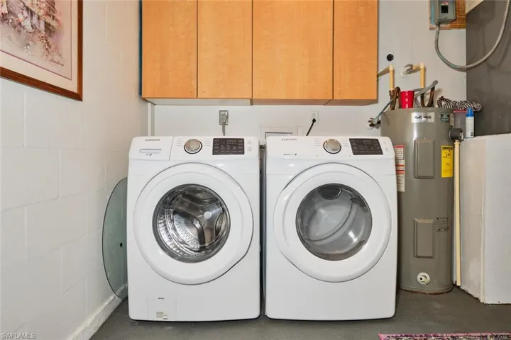 Laundry area with cabinets, separate washer and dryer