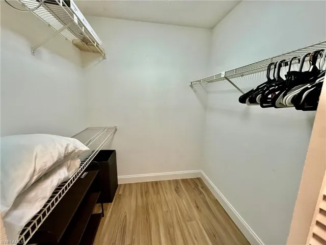 Walk in closet in primary bedroom.