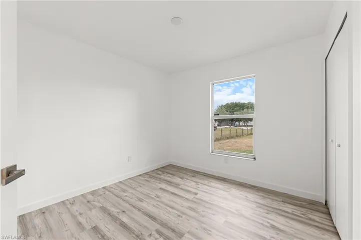 Unfurnished bedroom with a closet and light wood-style floors