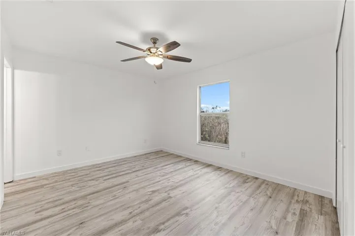 Spare room featuring light wood finished floors and a ceiling fan