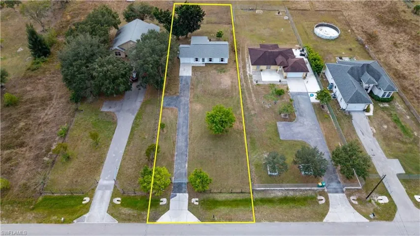 Aerial view of residential area featuring property boundaries highlighted