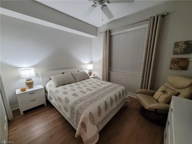 Bedroom with ceiling fan and dark hardwood / wood-style flooring