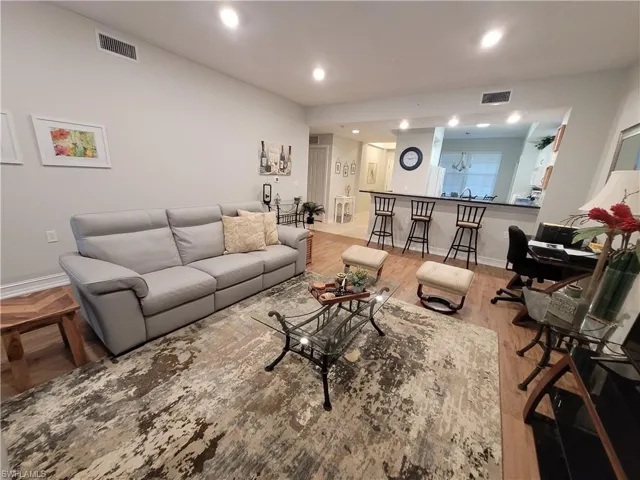 Living room with wood-type flooring