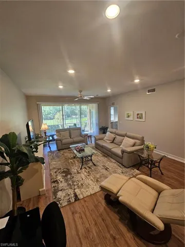 Living room featuring wood finished floors and recessed lighting