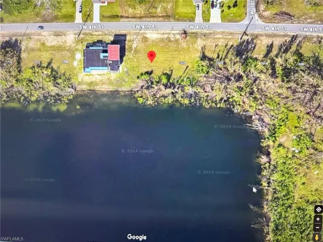 Birds eye view of property with a water view